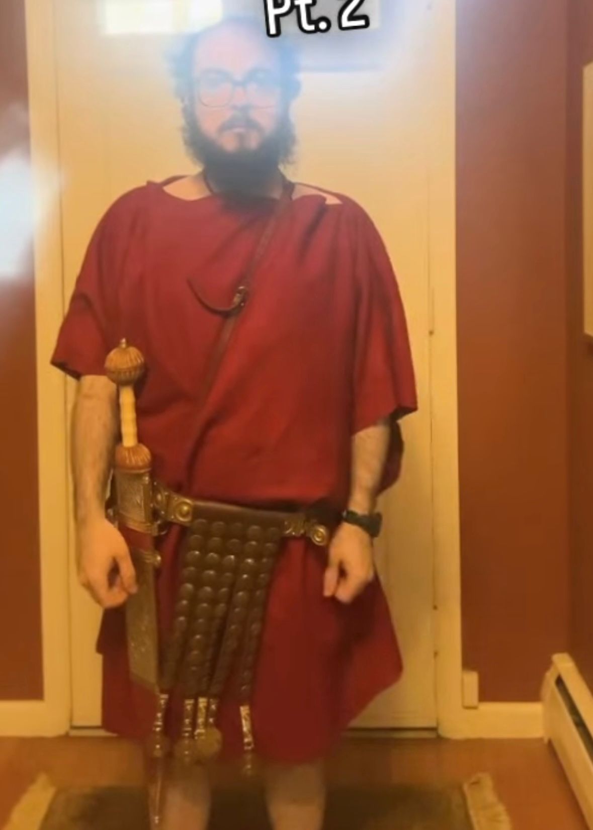 Nick, modeling a bright red Roman-style hand-made tunic made of hand-dyed wool